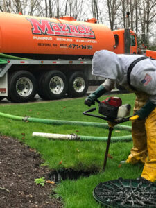 Using a crust buster tool to stir the septic tank