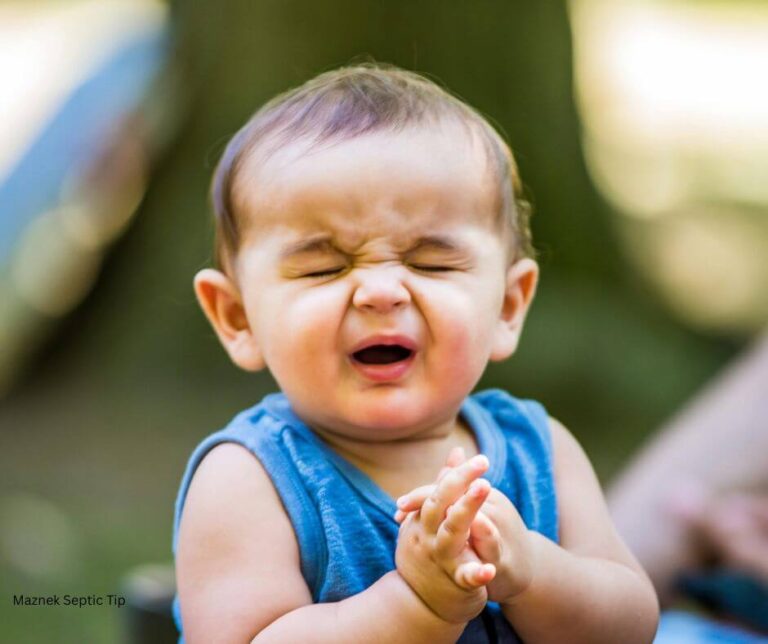 Toddler squinting eyes and making funny nose