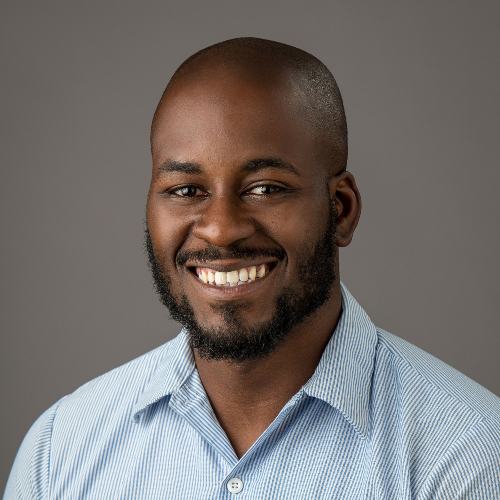 Bearded and mustached black man wearing blue shirt