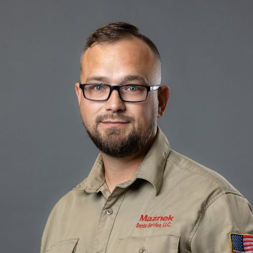 Young man wearing dark rim glasses and tan workshirt