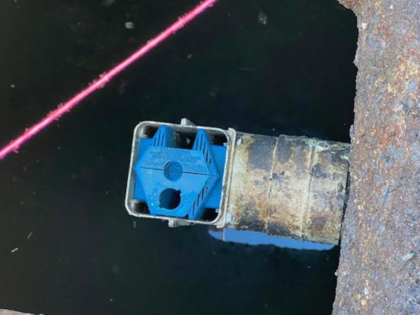 Closeup of metal and blue plastic septic strainer