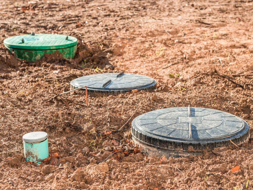 3 round septic tank riser caps above ground